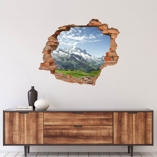 Wandaufkleber Wandtattoo in Form eines Wanddurchbruchs mit Blick auf die Berge über einer Kommode