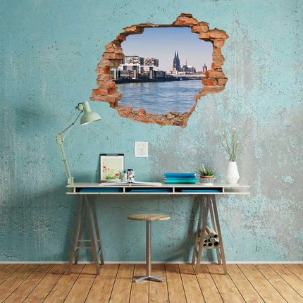 Wandaufkleber Wandtattoo in Form eines Wanddurchbruchs  von Köln als Hauptbild über dem Schreibtisch an einer blauen Wand