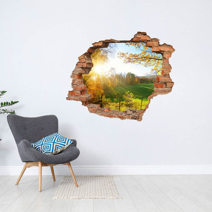 Wandaufkleber Wandtattoo in Form eines Wanddurchbruchs  von einer Waldlichtung als Hauptbild neben einem grausen Sessel