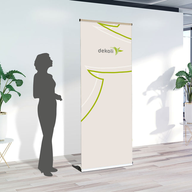 RollUp Slim elegantes Bannerstand mit schmaler Kassetten Vorderseite. Beispiel mit Größenvergleich . bedruckt mit Wunschmotiv und Expressproduktion.